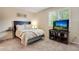 Cozy bedroom with a comfortable bed, television, shutters, and soft neutral tones at 11830 Snowshoe Dr, Parker, CO 80138