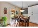 Bright dining area with hardwood floors and sliding glass door to outdoor seating at 11830 Snowshoe Dr, Parker, CO 80138