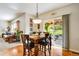 Bright dining area with hardwood floors, view of the outdoor patio, and a wooden table and chairs at 11830 Snowshoe Dr, Parker, CO 80138