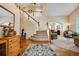 Inviting home foyer featuring hardwood floors, staircase, and a view into the living and dining areas at 11830 Snowshoe Dr, Parker, CO 80138