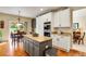 Open concept kitchen with granite counters, center island, and stainless steel appliances at 11830 Snowshoe Dr, Parker, CO 80138
