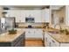 Kitchen featuring stainless steel appliances, granite counters, and white cabinetry at 11830 Snowshoe Dr, Parker, CO 80138