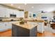 Open kitchen with granite countertops, stainless appliances, and seamless flow to the living area at 11830 Snowshoe Dr, Parker, CO 80138