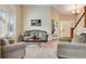 Comfortable living room featuring a large window, staircase, and glass french doors at 11830 Snowshoe Dr, Parker, CO 80138