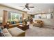 Cozy living room with a large window and seamless connection to the adjacent kitchen at 11830 Snowshoe Dr, Parker, CO 80138