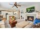 Warm and inviting living room with a cozy fireplace and seamless flow to the kitchen at 11830 Snowshoe Dr, Parker, CO 80138