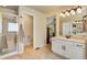 Well-lit main bathroom featuring a glass shower, vanity with cabinets, and tiled floor at 11830 Snowshoe Dr, Parker, CO 80138