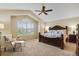 Spacious main bedroom with vaulted ceiling, ceiling fan, and large window with shutters at 11830 Snowshoe Dr, Parker, CO 80138