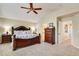 Spacious bedroom featuring a decorative dark-wood bed frame, carpet, and natural-tone walls at 11830 Snowshoe Dr, Parker, CO 80138