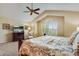 Comfortable bedroom with vaulted ceiling, carpet, window with shutter, and entertainment center at 11830 Snowshoe Dr, Parker, CO 80138