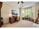Bright office with a vaulted ceiling, bay window, wooden desk, and comfortable chair at 11830 Snowshoe Dr, Parker, CO 80138