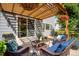 Outdoor patio with pergola, comfortable seating, decorative pillows, and views of the backyard at 11830 Snowshoe Dr, Parker, CO 80138