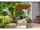 Covered patio featuring outdoor seating, lush greenery, a grill, and a stone walkway at 11830 Snowshoe Dr, Parker, CO 80138