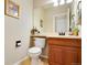 Cozy powder room featuring charming decor and a well-lit mirror creating a fresh and inviting space at 11830 Snowshoe Dr, Parker, CO 80138