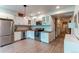 Modern basement kitchen with white cabinets, wood countertops, and stainless steel appliances at 3448 Ghost Dance Dr, Castle Rock, CO 80108