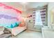 Colorful bedroom with a twin bed and geometric wall at 3448 Ghost Dance Dr, Castle Rock, CO 80108