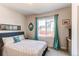 Bedroom with teal curtains, mirror, and queen-sized bed at 3448 Ghost Dance Dr, Castle Rock, CO 80108