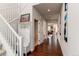 Bright hallway with hardwood floors and access to living areas at 3448 Ghost Dance Dr, Castle Rock, CO 80108