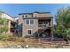 Two-story home with deck, showcasing modern elevation and backyard at 3448 Ghost Dance Dr, Castle Rock, CO 80108