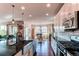 Bright kitchen featuring an island, stainless steel appliances, and hardwood floors at 3448 Ghost Dance Dr, Castle Rock, CO 80108