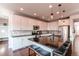 Modern kitchen with a large island, stainless steel appliances, and dark countertops at 3448 Ghost Dance Dr, Castle Rock, CO 80108