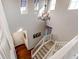 Elegant staircase with hardwood floors and chandelier at 3448 Ghost Dance Dr, Castle Rock, CO 80108