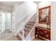 Basement stairs with wood railing and decorative artwork at 3448 Ghost Dance Dr, Castle Rock, CO 80108