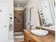 Bathroom featuring a shower with brown tile, and a white sink and countertop at 1965 Jasmine St, Denver, CO 80220