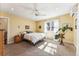 Bright bedroom features neutral carpet, a ceiling fan, and light yellow walls at 1965 Jasmine St, Denver, CO 80220