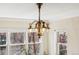 Close up of chandelier and dining room windows overlooking exterior brick building at 1965 Jasmine St, Denver, CO 80220