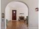 Charming entryway featuring hardwood floors, an arched doorway, and unique architectural details at 1965 Jasmine St, Denver, CO 80220