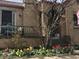 Quaint home featuring a classic brick facade, front porch and vibrant tulip landscaping at 1965 Jasmine St, Denver, CO 80220