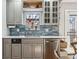Bright kitchen featuring stainless steel dishwasher and sink, and stylish backsplash and cabinetry at 1965 Jasmine St, Denver, CO 80220