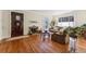 Cozy living room featuring a fireplace, hardwood floors, and a decorative front door at 1965 Jasmine St, Denver, CO 80220