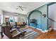 Inviting living room with a ceiling fan, ample seating, and large windows for natural light at 1965 Jasmine St, Denver, CO 80220