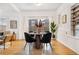 Bright dining area with wooden table and four black chairs, and view to backyard at 4743 Tejon St, Denver, CO 80211