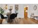 Dining area with wooden table and four black chairs, and kitchen view at 4743 Tejon St, Denver, CO 80211