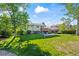 A sprawling backyard features lush grass and mature trees, ideal for outdoor enjoyment at 9430 Osceola St, Westminster, CO 80031