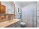 Clean bathroom with vanity, decorative tile backsplash, and shower with curtain at 9430 Osceola St, Westminster, CO 80031