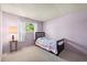 Comfortable bedroom featuring lavender walls, a cozy bed, and natural lighting at 9430 Osceola St, Westminster, CO 80031