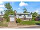 Charming two-story home with a brick facade, attached garage, well-kept lawn, and mature trees at 9430 Osceola St, Westminster, CO 80031