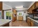 Cozy kitchen featuring wooden cabinets, durable countertops, and sliding glass door to the deck at 9430 Osceola St, Westminster, CO 80031