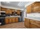 Well-equipped kitchen with stainless steel appliances, brick backsplash, and wooden cabinets at 9430 Osceola St, Westminster, CO 80031