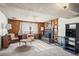 This cozy living room features wood paneling and a brick fireplace for a warm and inviting atmosphere at 9430 Osceola St, Westminster, CO 80031