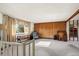 Spacious living room with wood paneled wall, large window, and views of the outside at 9430 Osceola St, Westminster, CO 80031