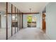 Bright living room with wood beam, mirrored wall, and sliding glass door to a wooden deck at 9430 Osceola St, Westminster, CO 80031