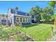 Large backyard with lush lawn, mature trees, and a charming garden at 4643 S Vivian Ct, Morrison, CO 80465