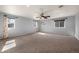Large carpeted bedroom features a ceiling fan and three windows, offering ample natural light at 4643 S Vivian Ct, Morrison, CO 80465