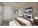 Bright bedroom with large windows, a padded headboard, bench seat, and minimalist artwork at 4643 S Vivian Ct, Morrison, CO 80465