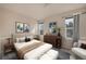Beautiful bedroom with large windows, modern furniture, and tasteful decor at 4643 S Vivian Ct, Morrison, CO 80465